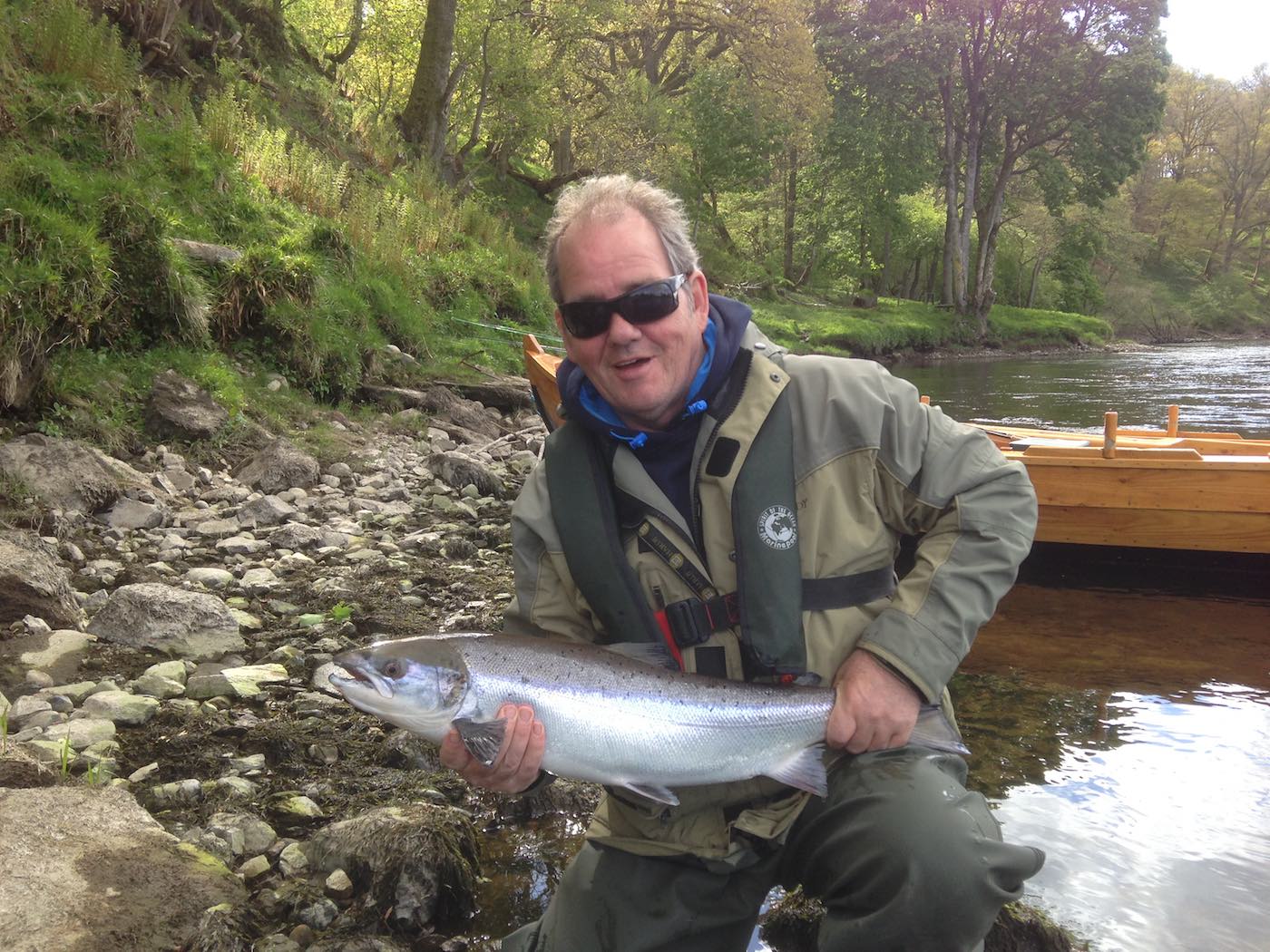 Here's salmon fisher Willie Logan with a fantastic fresh run salmon at the neck of the Rock Pool on the Kinnaird beat of the River Tay. You can see the traditional Tay salmon boat in the background which assisted with the capture of this fish along with Willie's professional River Tay salmon guide.