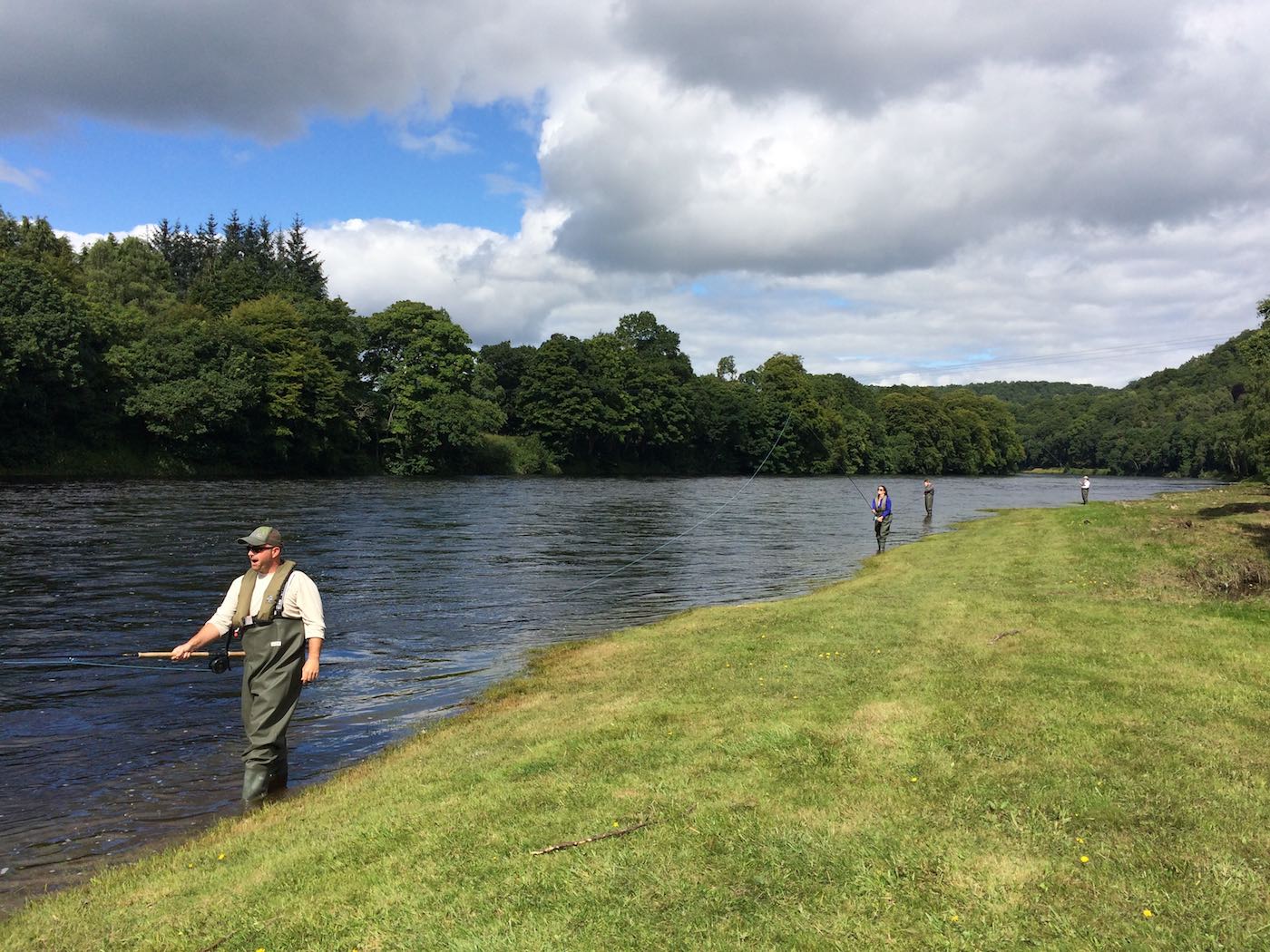 Here's a group of salmon fishing holiday guests testing out their newly learned Spey casting and riverbank movement techniques on the left bank of the River Tay's Cottar Pool on the Newtyle Beat. This perfect green grassy bank makes a perfect salmon pool for teaching salmon fishing guests.