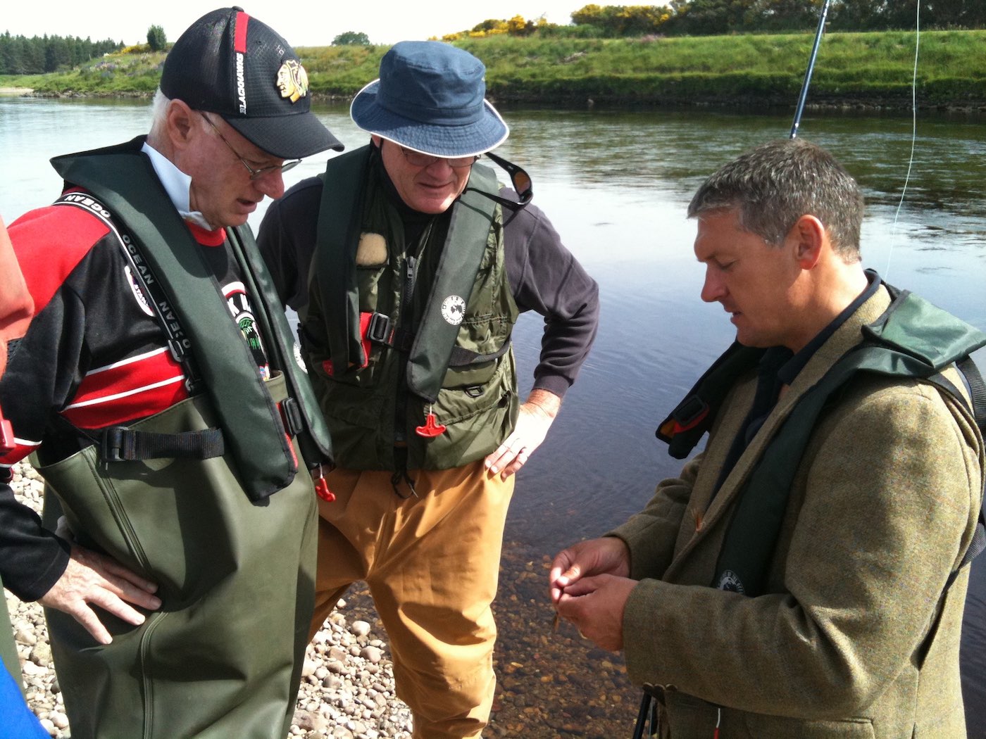 Here's a group of Canadian salmon fishers who had come to fish the River Tay learning how we tie our salmon flies onto the leader. This photo was taken near Murthly on the River Tay in Perthshire while professional salmon guide Jock Monteith was teaching these salmon fishing holiday guests the basic salmon fishing skills.