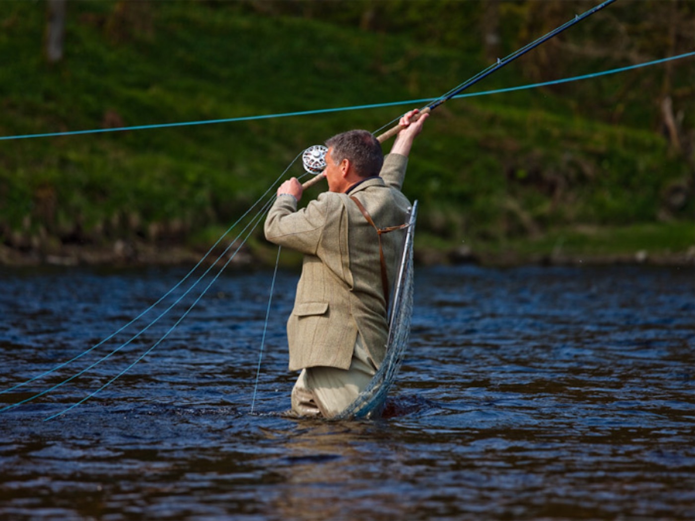 Here's a fine shot of the 'swing' which is the middle section of the Spey cast between the 'lift' and the 'power stroke'. Look how perfectly taut the salmon fly line is for perfect energy transfer and full fly line energy power retention. This fantastic action photograph was captured by at the Meetings Pool on the Lower Kinnaird salmon beat near Dunkeld. I was working as a professional salmon fly fishing instructor when this fine shot was taken on the River Tay.