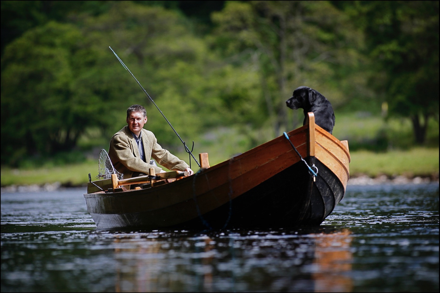 Here's a shot of myself while serving as a professional River Tay salmon fishing guide with my black labrador dog 'Selkie' out in the Cottar Pool of the Newtyle Beat near Dunkeld. This shot was taken by professional Scottish photographer Peter Sandground for the Glasgow Herald Magazine.