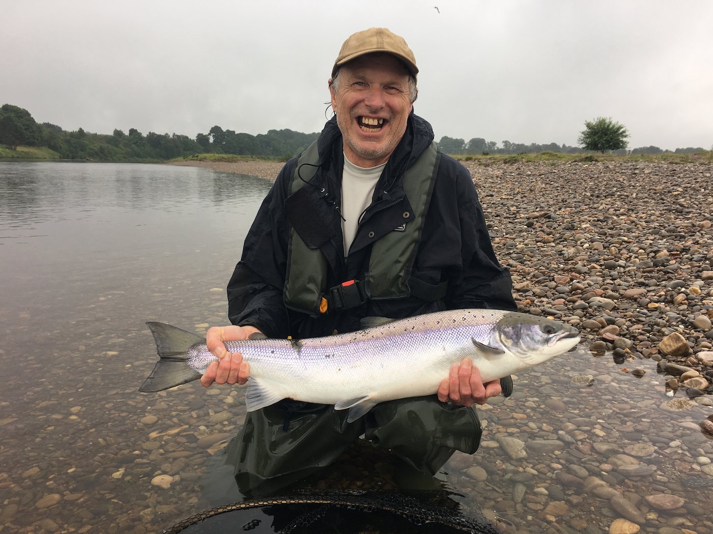 This American salmon fisher was rewarded for his trans Atlantic crossing with this perfect River Tay Summer salmon which was landed just upstream of the village of Meikleour while I was assisting him as his personal salmon fishing guide. When I took this photograph the guest couldn't stop smiling due to the sheer excitement of the capture of this fine fish.