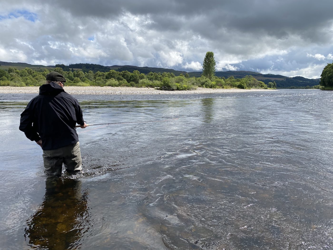 This shot was taken on the River Tay near Pitlochry during the Summer while I was the salmon guide for this fishing trip fisherman. Many anglers think salmon fishing is mainly about how well they can cast a fly but the truth of the matter is that the important thing to learn is how to move properly between each cast of the fly as that's logically what will place your fly in front of a cooperating salmon if your water coverage is good enough.