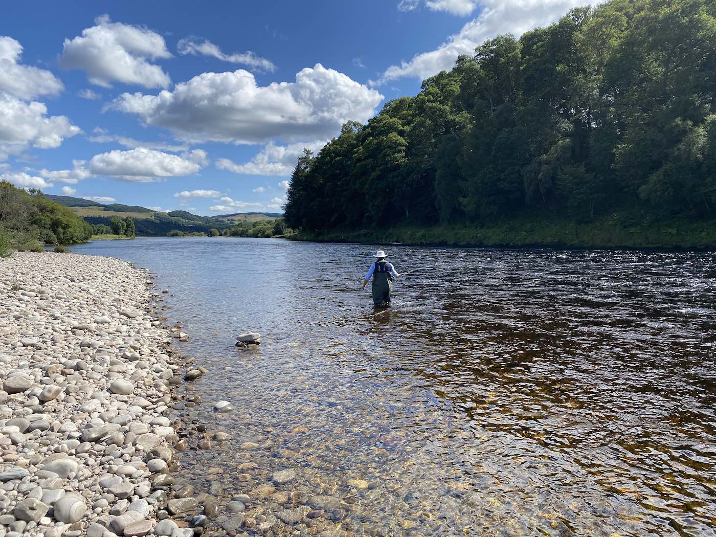 Look for unusual riverbank markers like a pile of stones as sometimes these are placed there by anglers to mark the location of salmon that have been showing. This shot was taken on the Meetings Pool of the River Tay near the Perthshire town of Pitlochry which is a popular salmon fishing location for anglers.