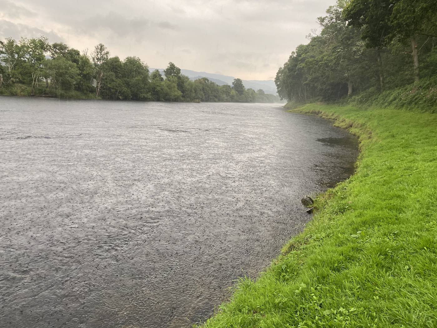 When the weather worsens on the rivers of Scotland it's always good to have a reliable waterproof jacket to hand to keep you bone dry while fishing. Look at the heavy rain bouncing off the surface of the River Tay in this shot from the Daffodil salmon lie pool on Kinnaird.