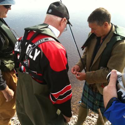 Here's Scottish salmon guide Jock Monteith showing a group of Canadian salmon fishing holiday guests how best to tie on a salmon fly. Much salmon fishing technical information is delivered to the fishing guests on a guided salmon fishing day including Spey casting lessons, how to move effectively between each cast and how to set the hook when a salmon takes the fly.
