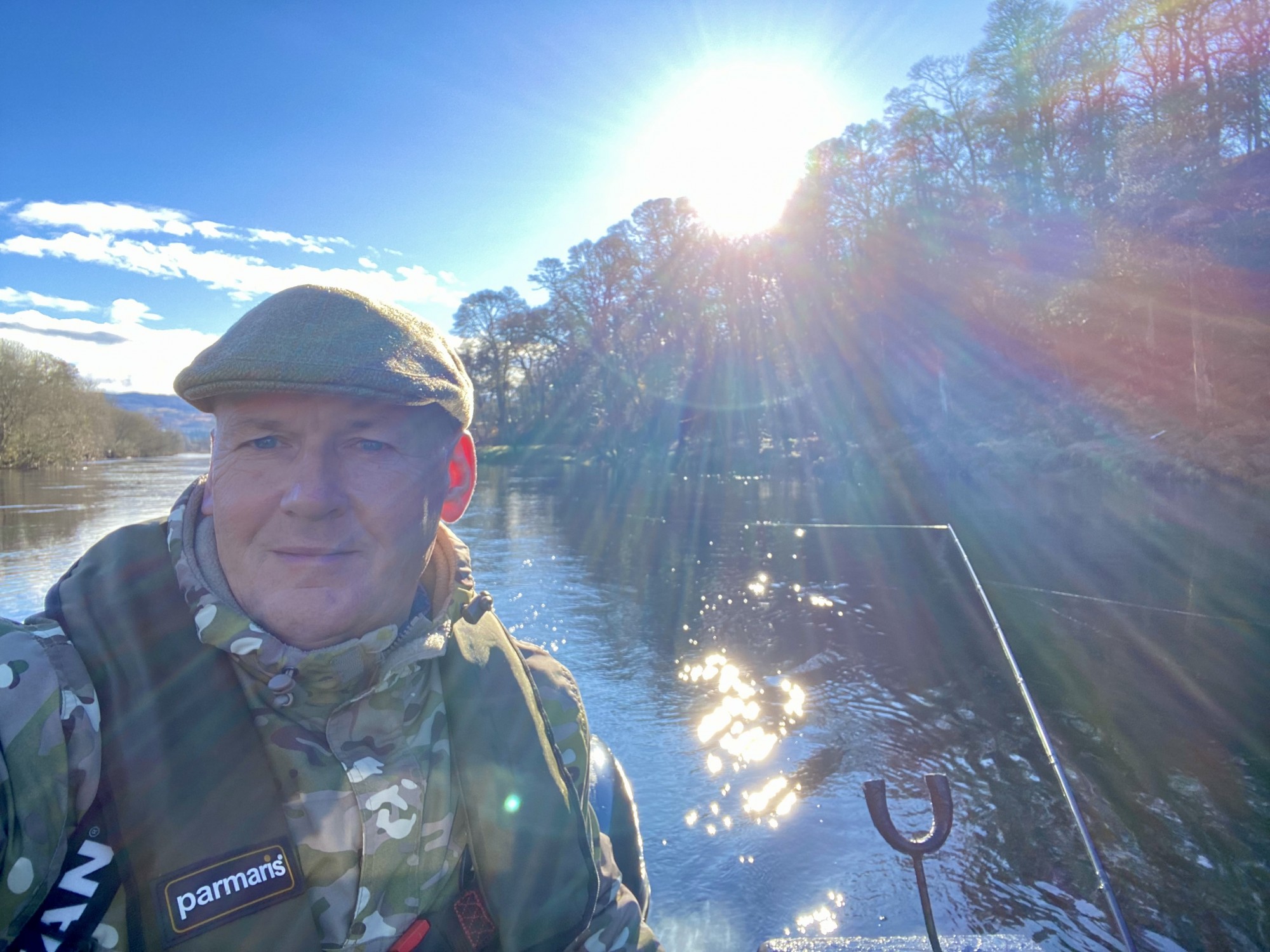 There's nothing more inspiring than the low Scottish sun appearing through the clouds on a cold early Spring fishing day to warm up the surface layer of the freezing cold river water as you can see in this photograph. This warmth is often an indicator trigger preceding the capture of an early Spring salmon so whenever I see this my expectation levels soar. I took this selfie during the early Spring month of February on the River Tay while out fishing from the boat near the River Tummel mouth.