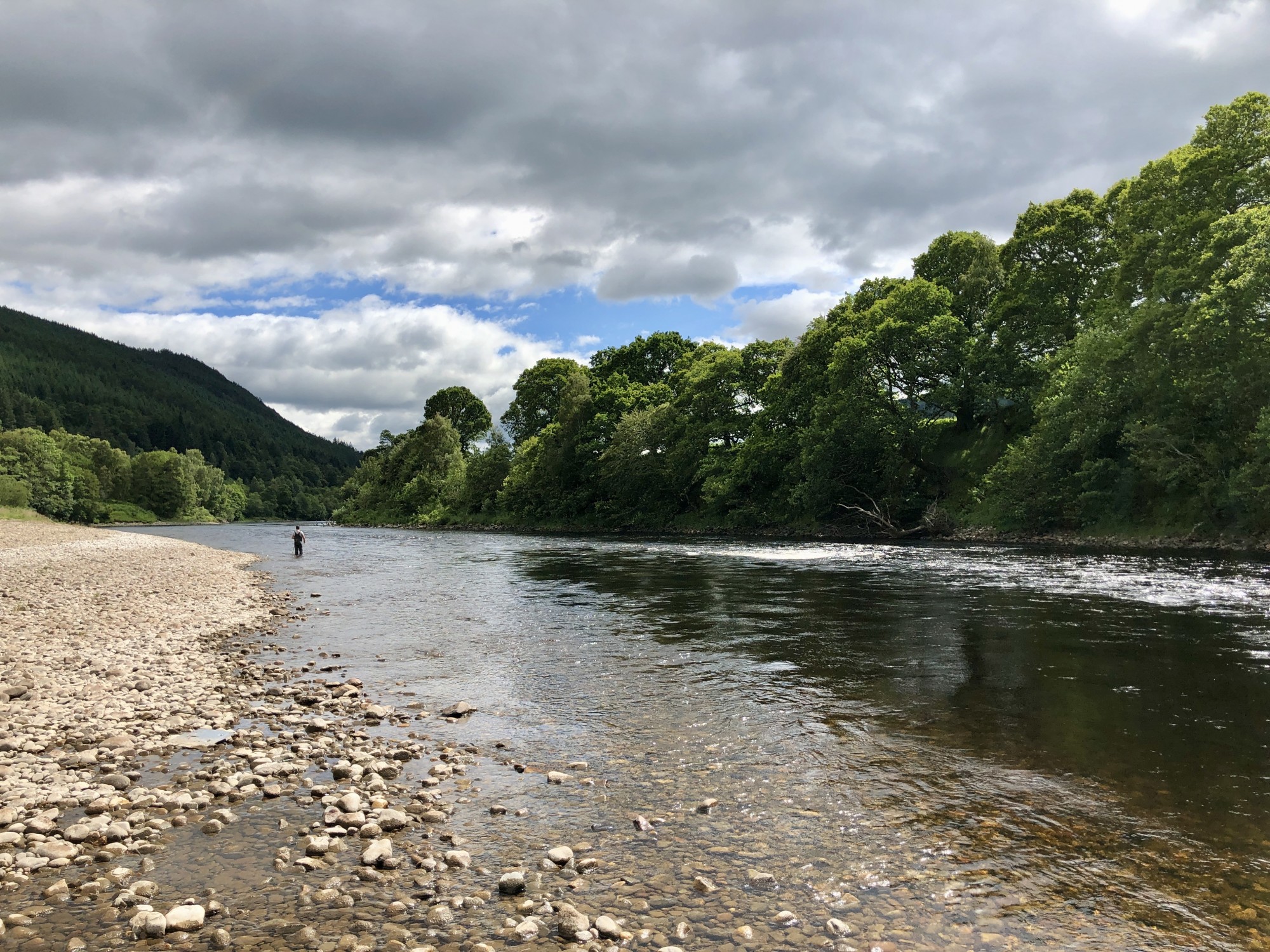 I took this beautiful downstream shot of the River Tay in Perthshire which is a famous Scottish salmon river. This lovely shot was taken a few miles upstream from the Perthshire town of Dunkeld. You can clearly see my salmon fishing guest a few hundred yards below me. The dark shadowy water just off the main current is a great Tay salmon holding area and is always worth fishing through.